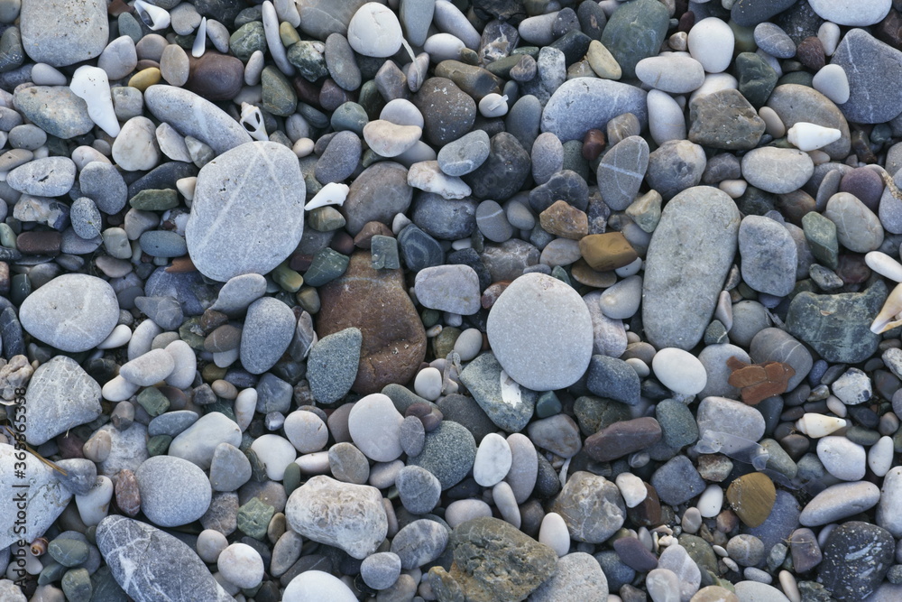 Closeup view of small stones on the beach with colorful pattern Closeup view of small stones on the beach with colorful pattern