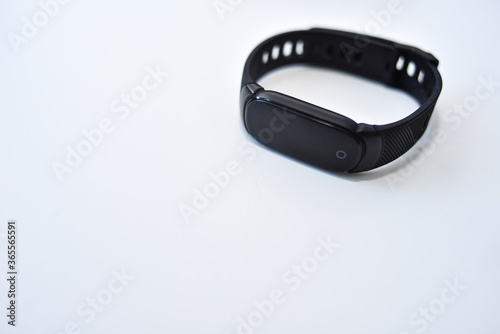 Sports black shoes and watches for monitoring your health on a white background