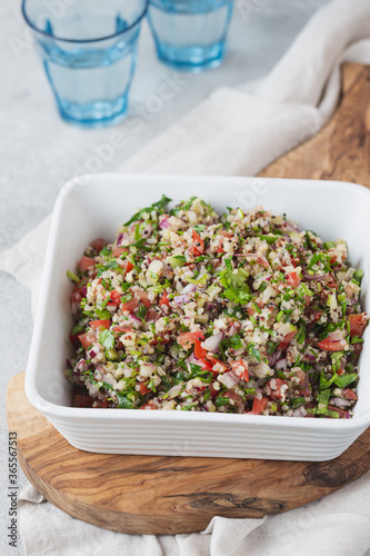 Quinoa Quinua salad with tomatoes and herbs in white bowl