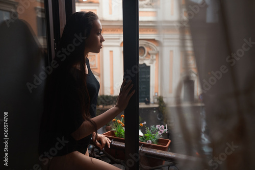 young woman looking at window