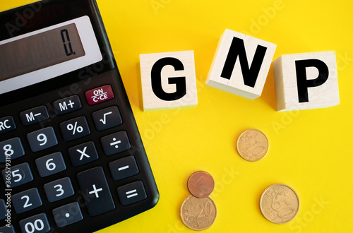 GNP Gross Domestic Product word made with wooden blocks on yellow background. photo