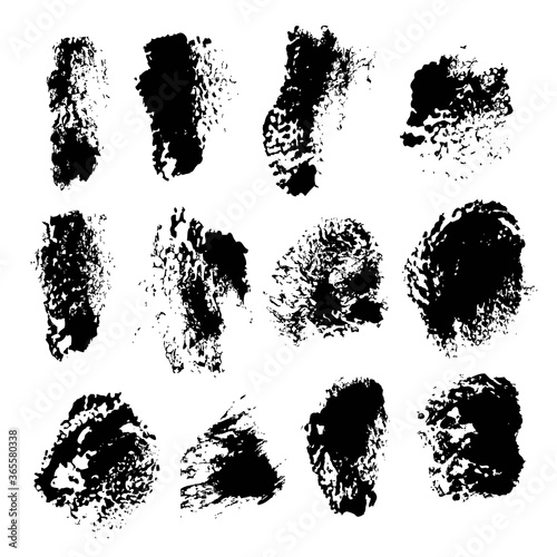 Texture smears of black dry paint spots on white paper 1