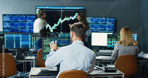 Fotografie Portrait of multi-ethnic team of traders and brokers working at stock exchange office