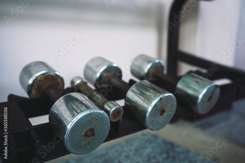 Stack of old dumbbell rusty in the gym