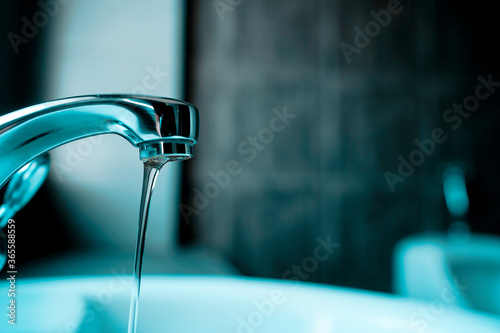 Closeup water flowing from faucet