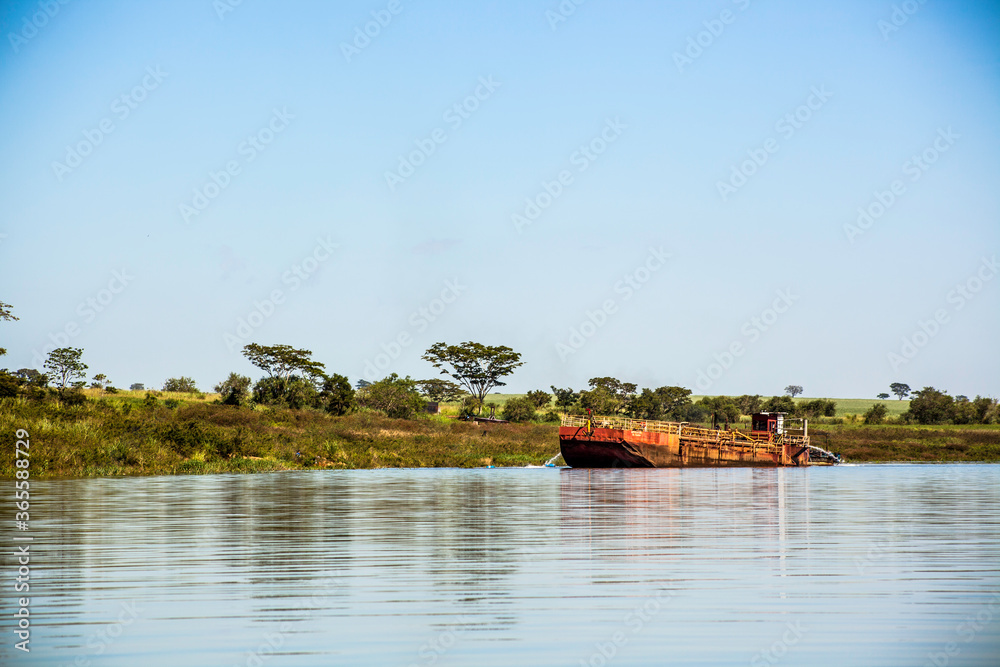 Guaraci, Sao Paulo, Brazil, April 08,2015. Boat extracts sand on the edge of an arm of Rio Grande on the border of the states of Sao Paulo and Minas Gerais, in the municipality of Guaraci