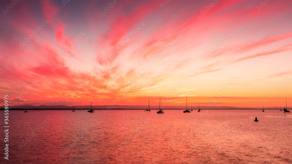 sunset over the sea at Scarborough Marina Queensland with boats in the foreground