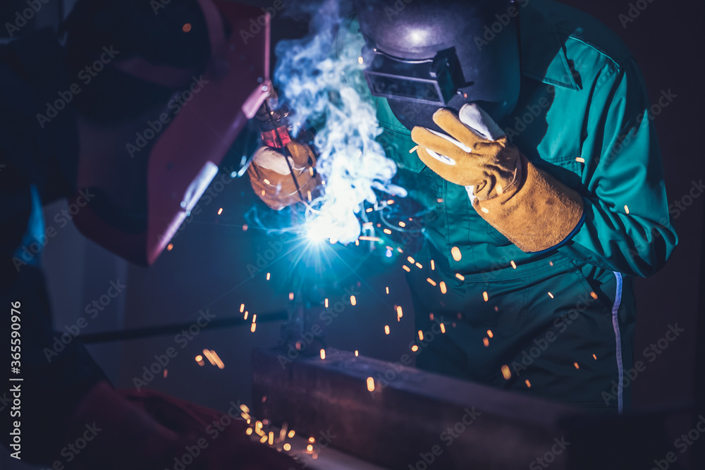 Metal welding steel works using electric arc welding machine to weld steel  at factory. Metalwork manufacturing and construction maintenance service by  manual skill labor concept. Stock Photo | Adobe Stock