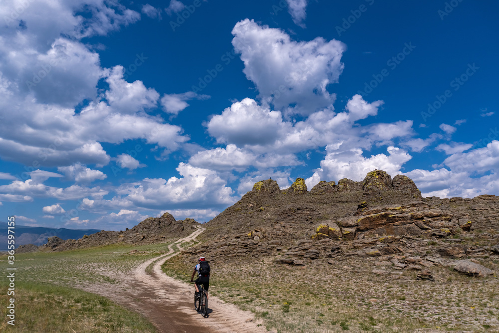A cyclist rides among the rocks on the Olkhon island