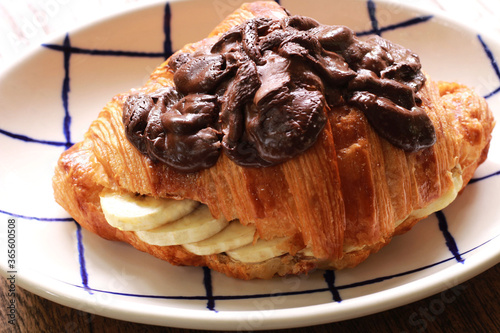 Croissant sandwich with banana and chocolate cream