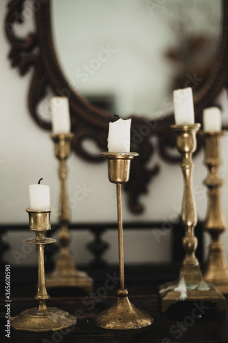 Antiques. Old candles and a mirror. Beautiful interior in the apartment
