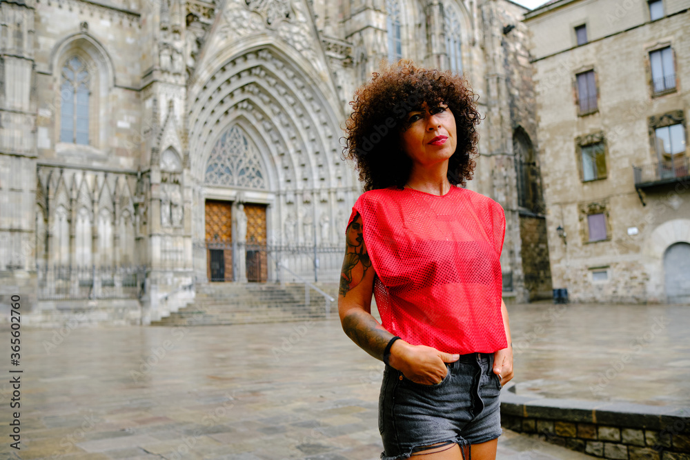 mature woman in front of Barcelona Cathedral with a red shirt