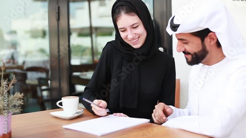 Arab couple signing a contract