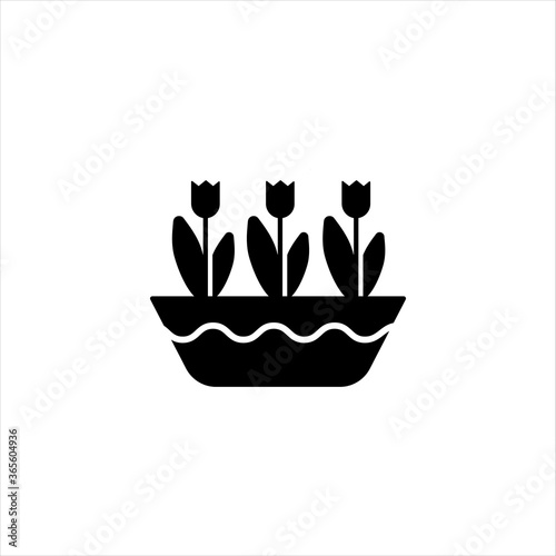 Tulips in a horizontal pot glyph icon. Solid vector black icon Solid vector black icon isolated on a white background. Logo illustration. Symbol of a garden or farm. 