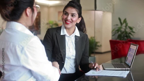 Indian banker getting documents signed from the client