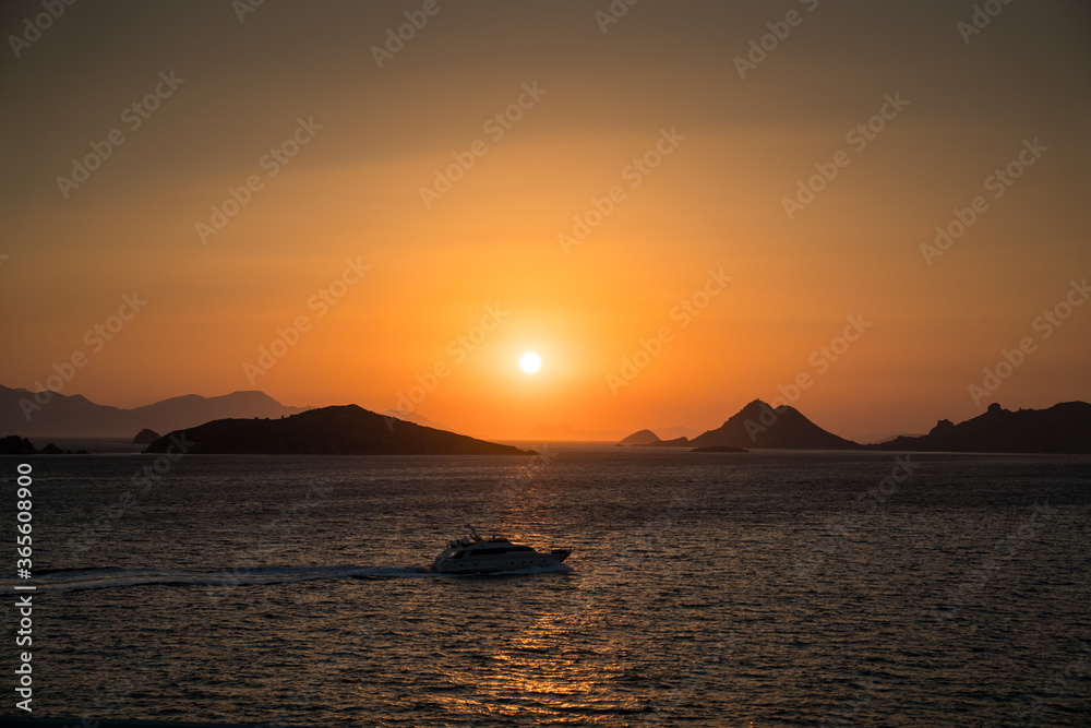Sea and the sunset over the islands. Vacation in Mediterranean sea. Turgutreis – Bodrum, Beautiful Sunset over the sea and mountains. Boat in the foreground