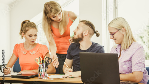 Students and teacher tutor in classroom