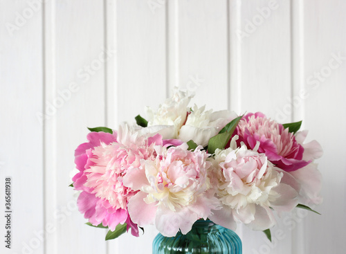 Fototapeta Naklejka Na Ścianę i Meble -  bouquet of light and bright pink peonies on a white Board background.
