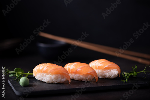 fresh salmon sushi on black board