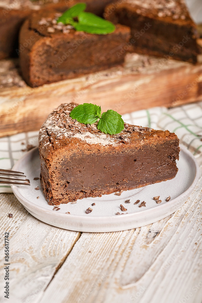 Close-up of homemade brownie chocolate cake on a plate. Cooking delicious desserts at home. Vertical shot