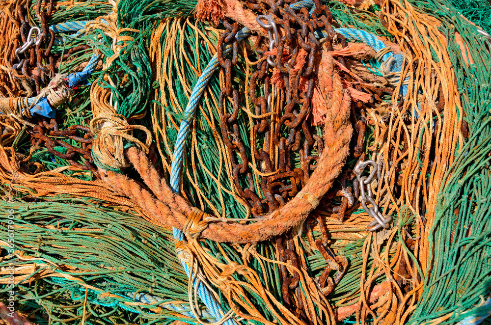 old green and orange fishing net and rusty chain
