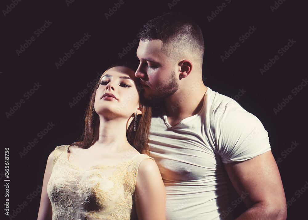 Sexy couple. Muscular handsome man undressing young sensual woman. Sexy