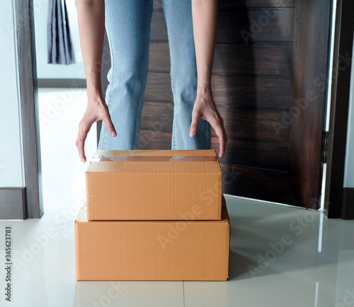 Quarantine or self isolated family receiving parcel box to door.