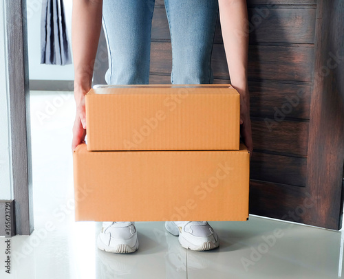 Quarantine or self isolated family receiving parcel box to door.