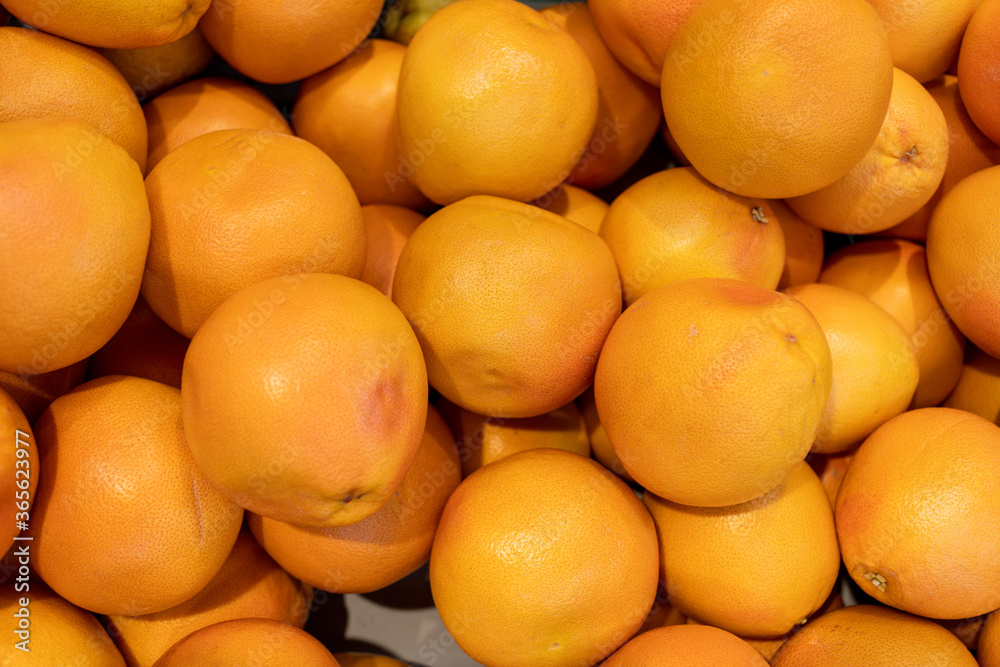 lots of fresh bright orange grapefruits lying one on top of the other. High quality photo lots of fresh bright orange grapefruits lying one on top of the other. High quality photo