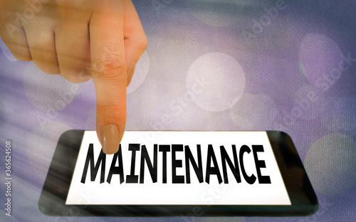 Writing note showing Maintenance. Business concept for method of preserving or maintaining someone or something Modern gadgets white screen under colorful bokeh background photo