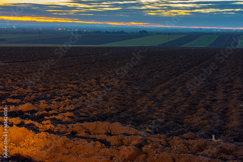 Plowed farmland at dusk in Vojvodina, Serbia photo