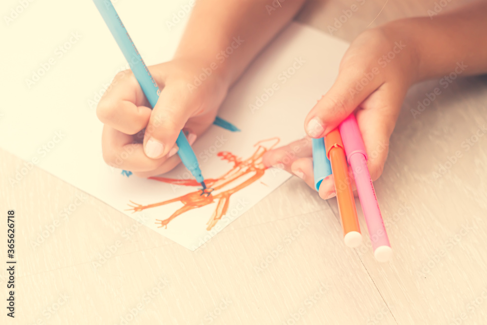 Favorite activity of the child. A happy family. The girl draws with colored markers. Girl's hands. Favorite activity of the child. A happy family. The girl draws with colored markers. Girl's hands.