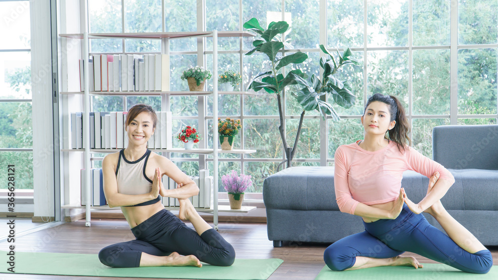 Asian adult women exercising with yoga at home. Asian adult women exercising with yoga at home.