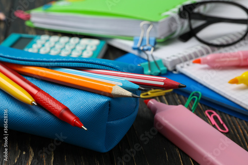 School supplies on wooden background, close up