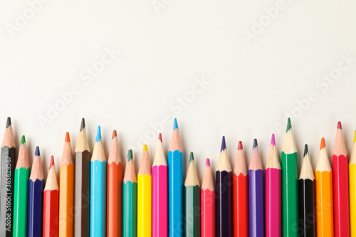 Colorful pencils on white background, space for text