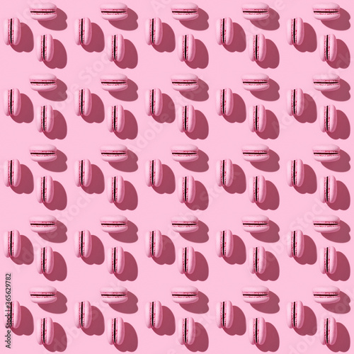 Seamless regular creative pattern of bright pink french cookies macarons.