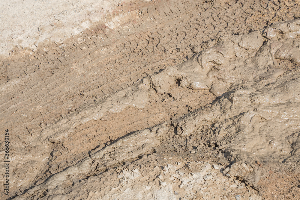 Wheel track on road muddy. Mud texture background. Wheel track on road muddy. Mud texture background.
