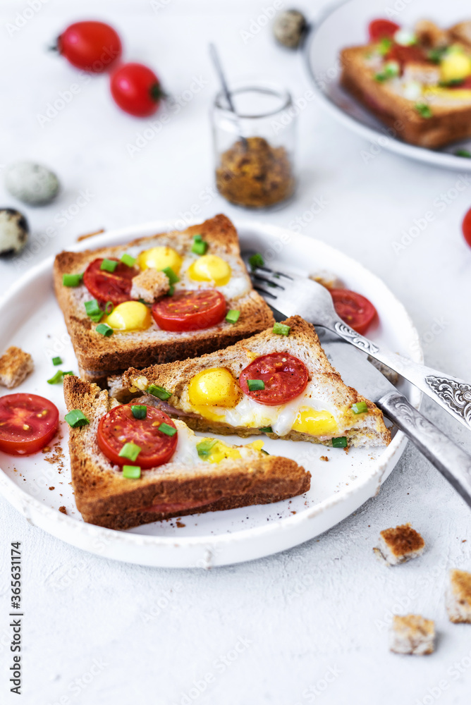 Ham and fried egg open sandwich, ham and fried egg on a gray concrete table. Сlose-up, top view.