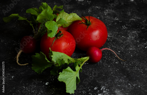 radish with tomatoes on a black background