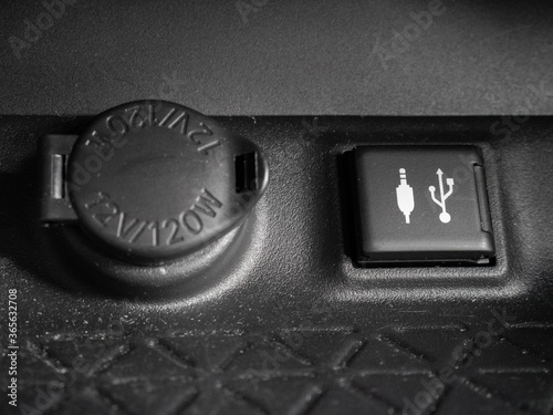 Closed covers of the power supply of a 12 volt car and the minijack and usb connection of the interior of a vehicle