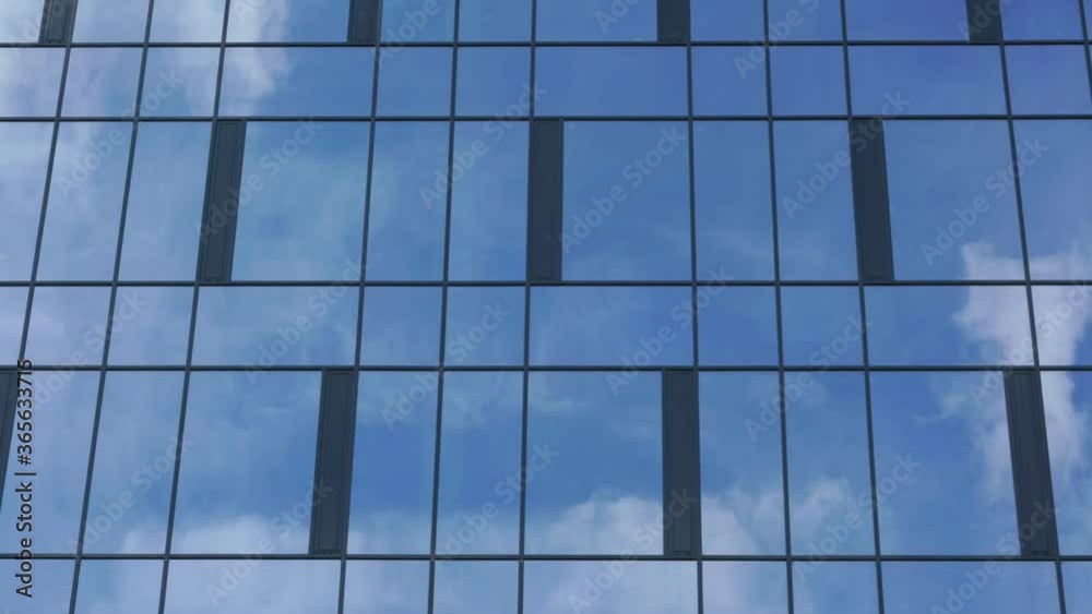 large white cumulus clouds reflecting in skyscraper glass facade float in blue sky on sunny day time lapse large white cumulus clouds reflecting in skyscraper glass facade float in blue sky on sunny day time lapse