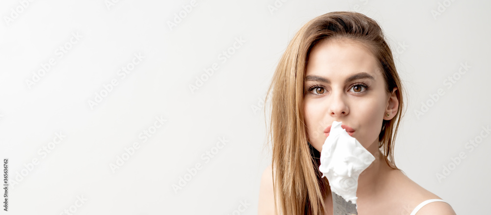 Portrait of young caucasian woman holding knife with shaving foam in front of her face on white background with copy space Portrait of young caucasian woman holding knife with shaving foam in front of her face on white background with copy space