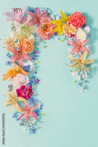 frame of beautiful garden flowers on paper background