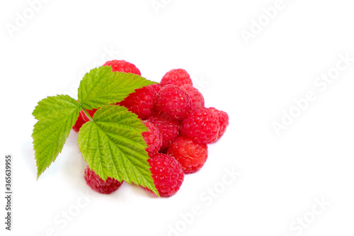 Ripe raspberry berry on a white background with a green leaf.