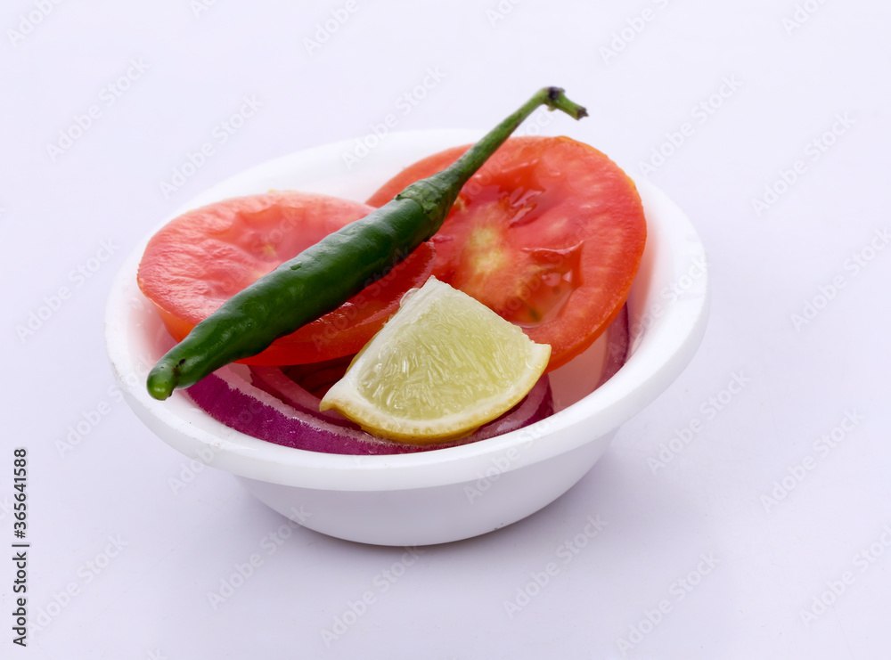 Chili, Tomato, lemon and onion in white bowl on white background Chili, Tomato, lemon and onion in white bowl on white background