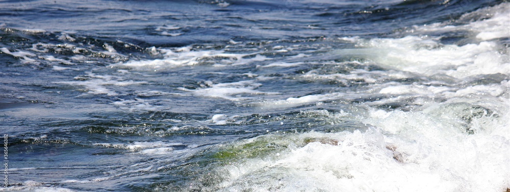 Waves crashing stones on the beach