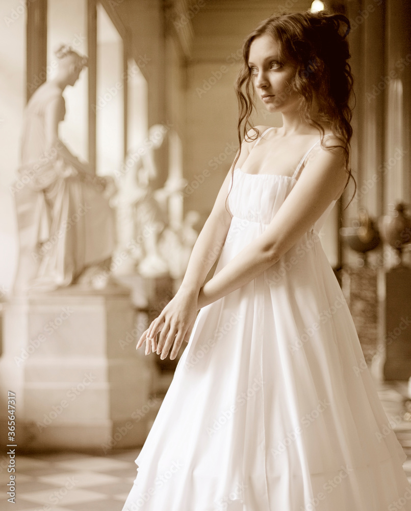 Fototapeta premium Portrait of a beautiful young victorian lady in white dress