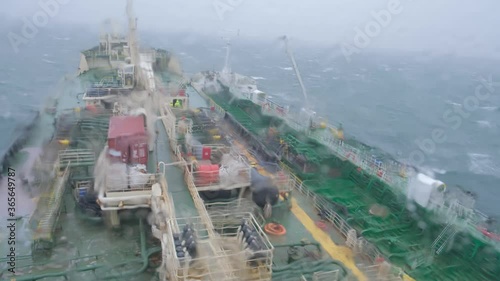 moored large industrial Natig Aliev and Rina tankers drift across sea during heavy storm at Danish port of Skagen raid photo