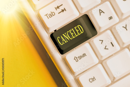 Conceptual hand writing showing Canceled. Concept meaning to decide not to conduct or perform something planned or expected Colored keyboard key with accessories arranged on copy space