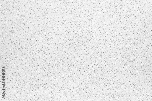 Plaster or cast material. Close up of a white background or texture. Irregular surface with grey and black pores.